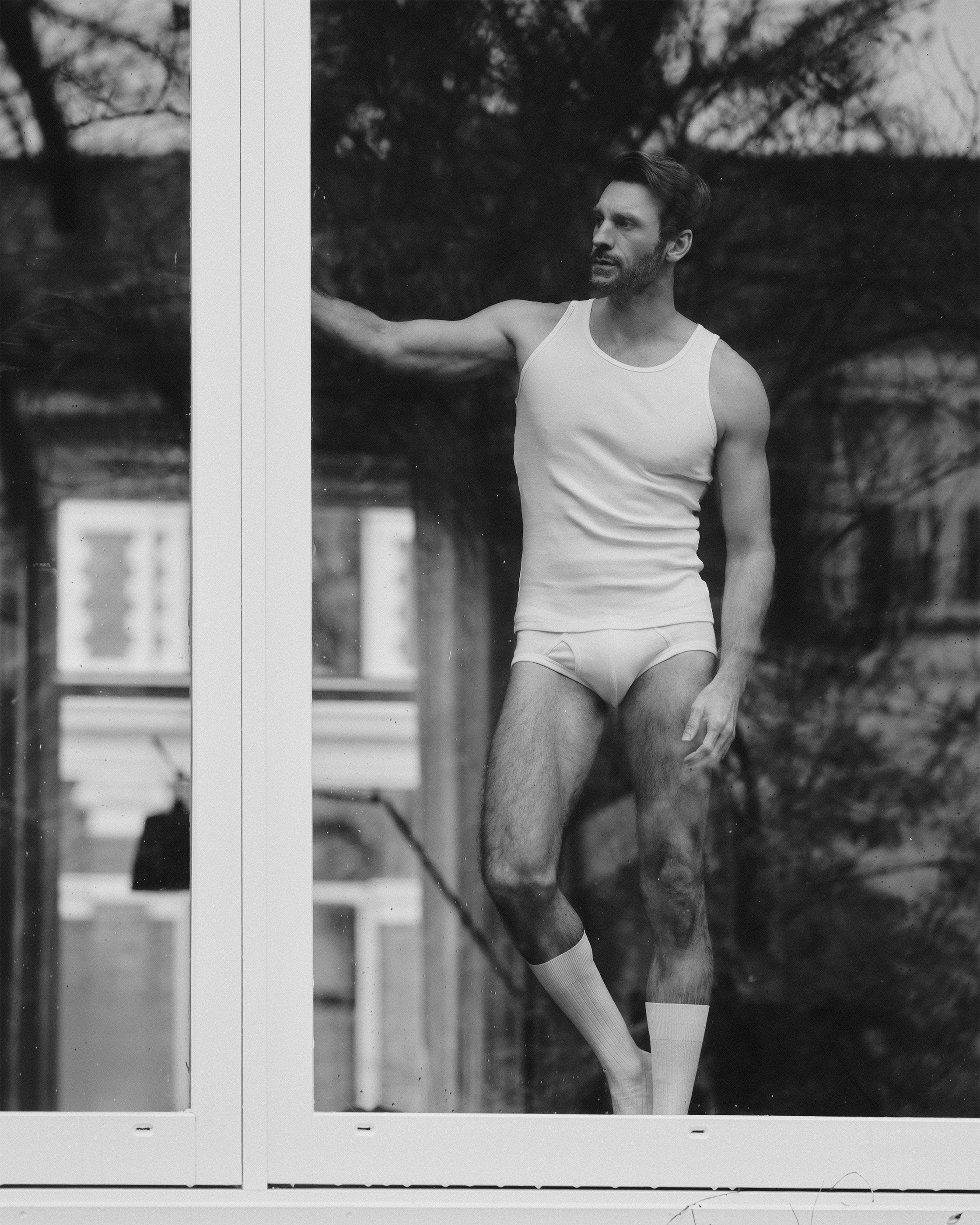 man wearing white cotton underwear set tank briefs socks by Erelong